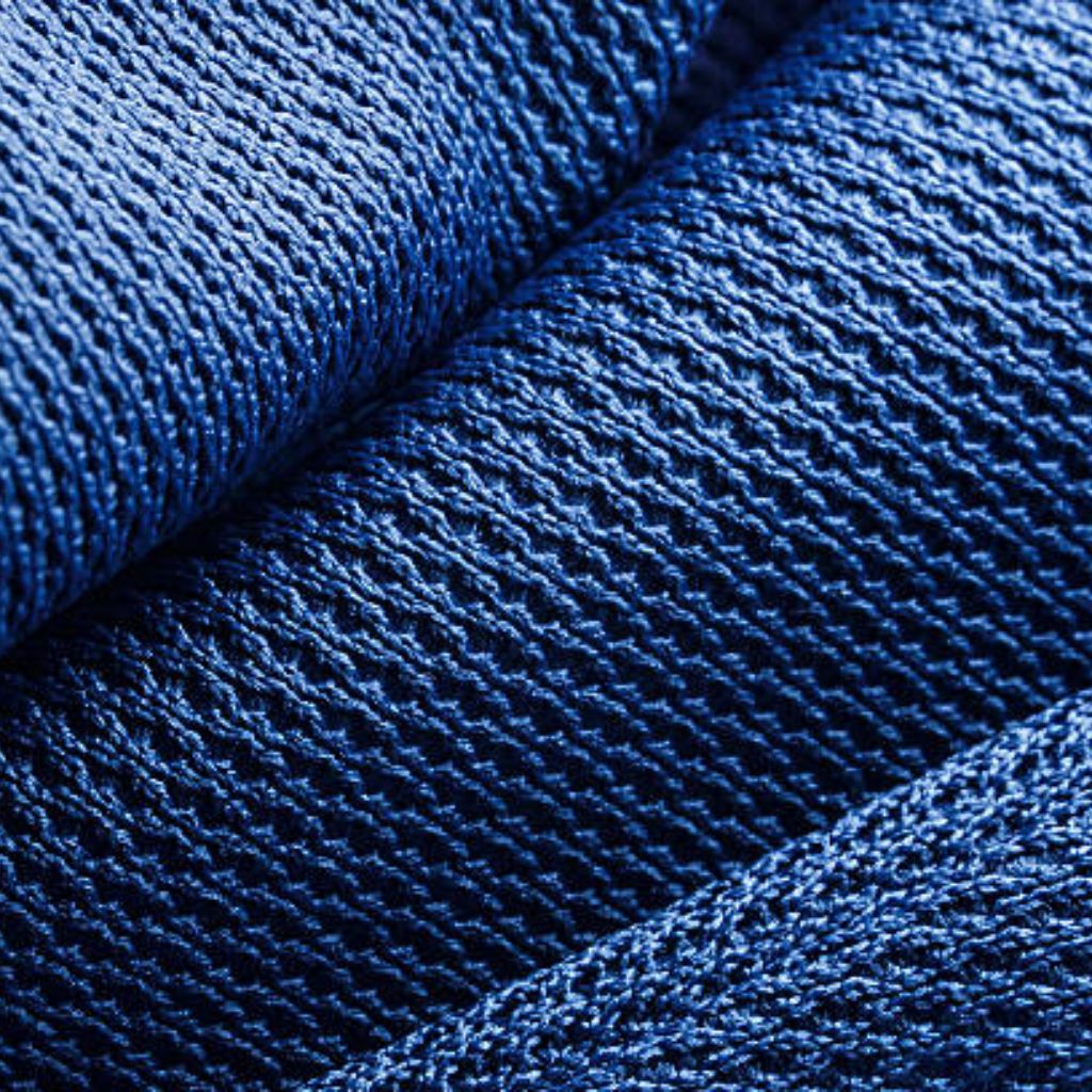 Hyper Flex Motion Knit: Engineered for Ultimate Flexibility 9 Macro view of richly textured blue knit fabric folds.Hyper Flex Motion Knit: