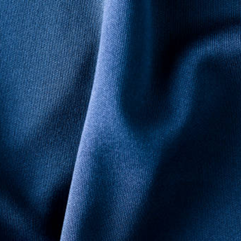 Close-up of dark blue fabric with a soft, smooth texture and subtle folds, suggesting a woven textile.
Sweat Flow Pro Fabric:
