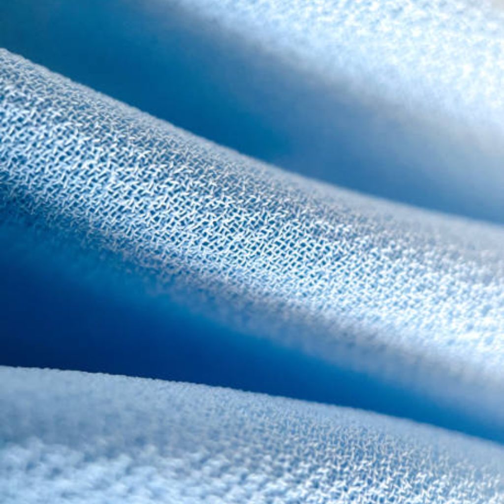 Ice Flow Athletic Fabric: Stay Cool During Intense Workouts 10 Close-up of light blue knitted fabric with a subtle, uniform pattern, showing soft folds.
Ice Flow Athletic Fabric: