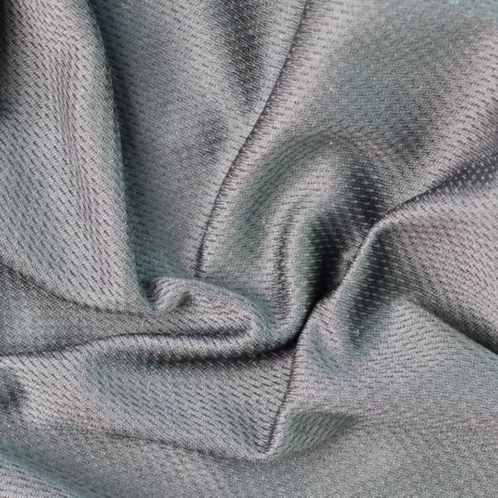 Close-up of textured gray fabric gathered and folded, creating shadows and highlights that emphasize the weave.
Flex Pro Sports Fabric: