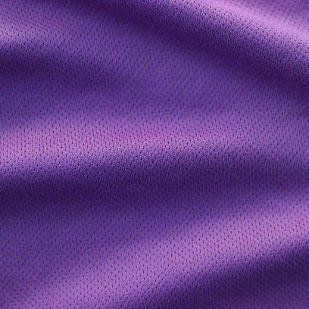 A close-up of purple fabric with a subtle dotted texture and soft folds, suggesting a breathable, athletic material.
Vapor Flow Athletic Fabric: