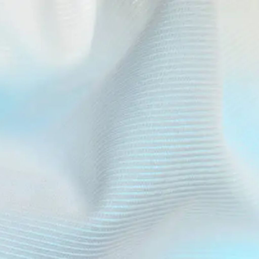 Ice Flow Athletic Fabric: Stay Cool During Intense Workouts 7 Alt text: "Close-up of light gray, quilted fabric with a subtle dotted pattern, showing soft folds and texture."
Ice Flow Athletic Fabric: