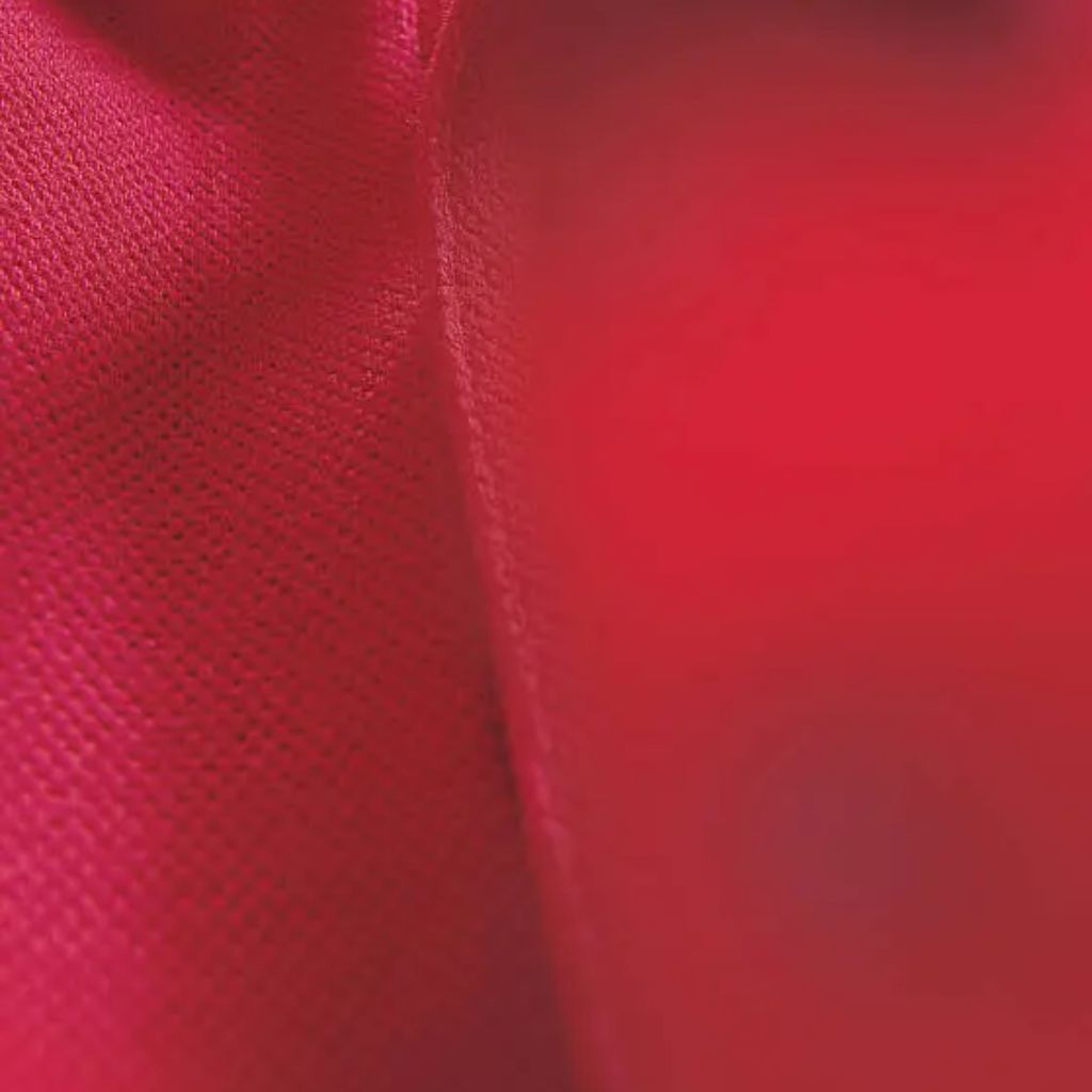 A close-up view of vibrant military-green textile with a fine, perforated mesh texture on the left, contrasted by a smooth, slightly reflective fabric panel on the right. The seam down the center divides the two textures, highlighting the contrast between the breathable knit-like surface and the solid material, suggesting durable winter jacket fabric with ventilation cues.
Ventra Cool Training Fabric: