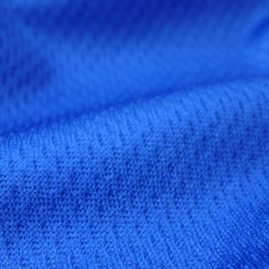 Close-up, grayscale fabric texture showing tight knit weave and fine fibers.
Breeze Weave Athletic Fabric: