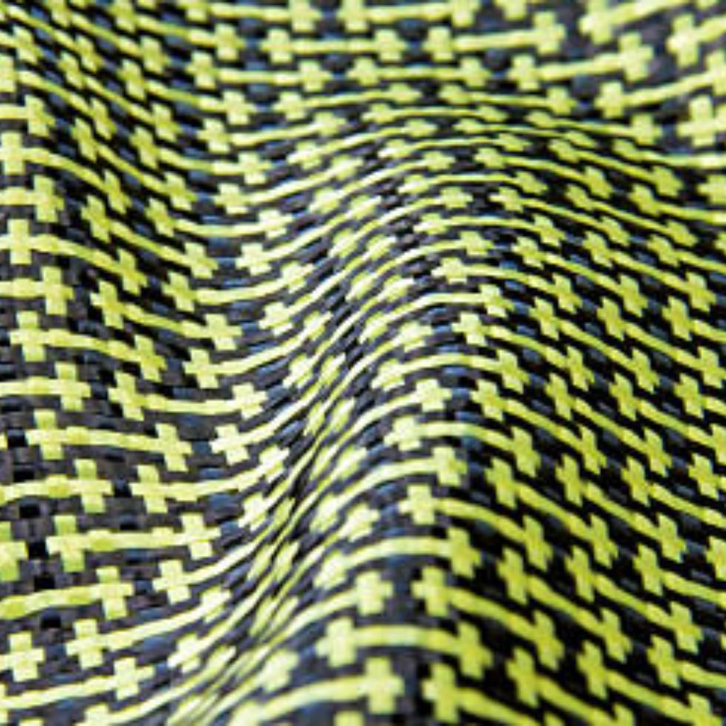 Ultra Motion Dynamic Stretch Weave: Advanced Sports Fabric 11 "Close-up of a dark woven fabric with bright yellow accent threads forming a grid pattern. The surface shows a wavy, undulating texture as the material drapes."
Ultra Motion Dynamic Stretch Weave: