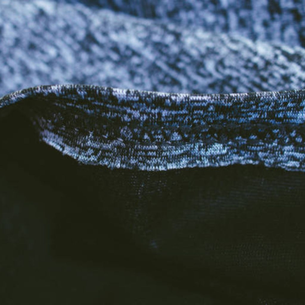 Ice Flux Performance Knit: Built for Speed, Cool & Comfort 11 Close-up of dual-texture winter jacket fabric: heathered blue-white knit upper transitioning to smooth, deep-navy solid base.
Ice Flux Performance Knit: