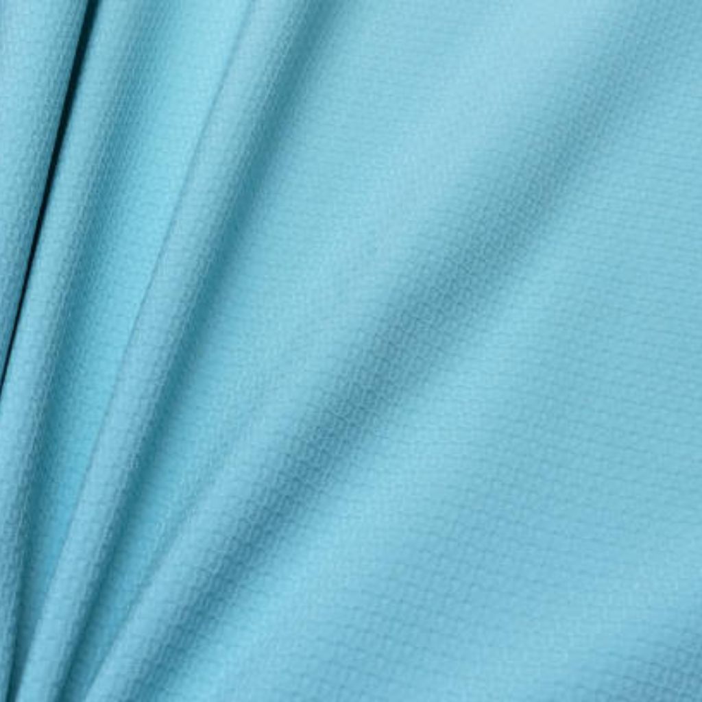 Glacier Cool Performance Fabric: Feel Cool, Stay Comfortable 11 "Close-up of light blue military-grade performance fabric showing a uniform grid of subtle raised square nodes across a matte, softly folded surface — engineered for water repellency and abrasion resistance."
Glacier Cool Performance Fabric: