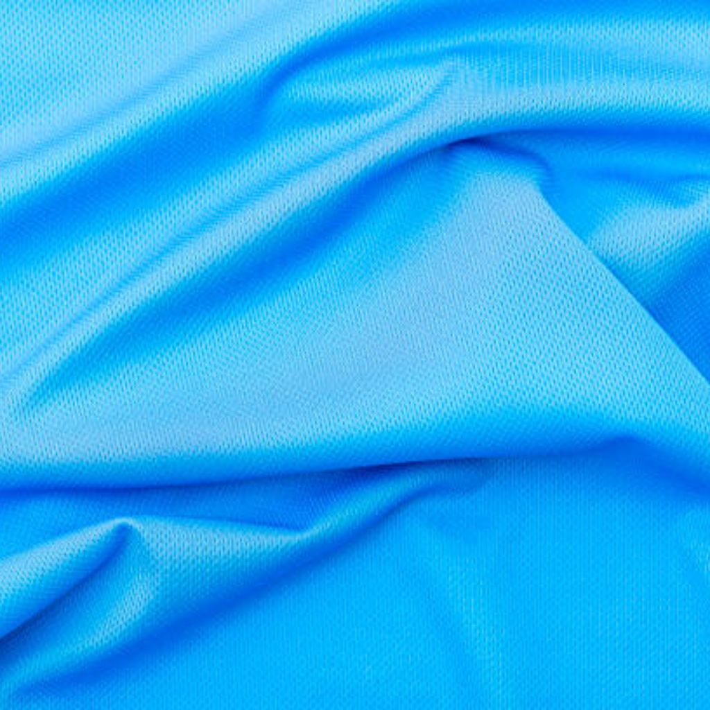 Long: A close-up of bright blue, perforated textile with visible folds and subtle seam lines, highlighting breathable fabric structure and dynamic drape.
Short: Close-up of bright blue perforated fabric with folds and seams.Ventra Cool Training Fabric: