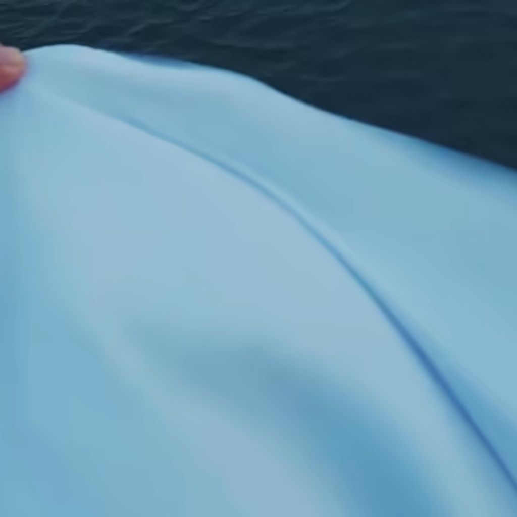 Glacier Dry Performance Fabric: Stay Cool, Dry & Game-Ready 10 Close-up of smooth light blue fabric with soft stretch and gentle surface foldsGlacier Dry Performance Fabric: