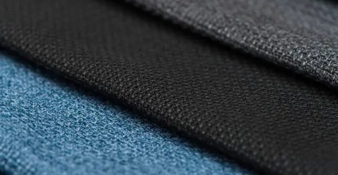 Close-up of textured performance fabric layers in blue and black showing breathable and durable material.Infinity Dry Performance Fabric: