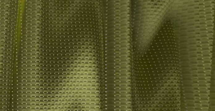 Olive green fabric with a raised, wavy texture and evenly spaced white dot pattern. Infinity Cool Tech Knit: