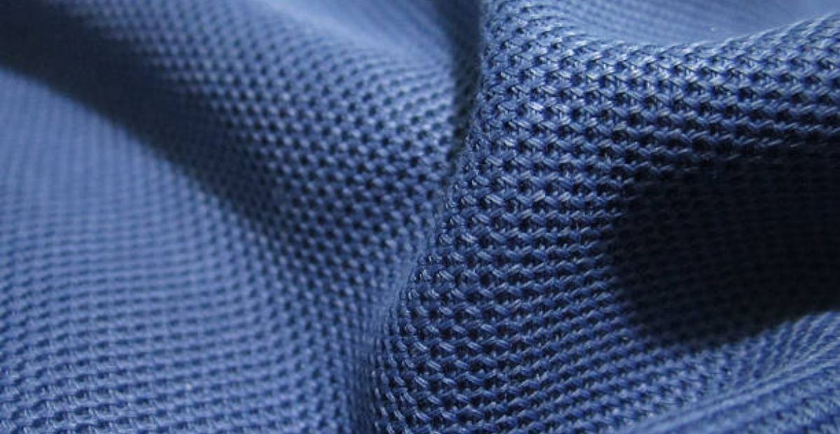 Rapid Dry Sports Knit: Train Hard, Stay Dry, Perform Better "Close-up of blue winter coat fabric showing a textured diamond-weave pattern with visible 3D texture and small diamond-shaped openings creating a breathable net-like structure." Rapid Dry Sports Knit: