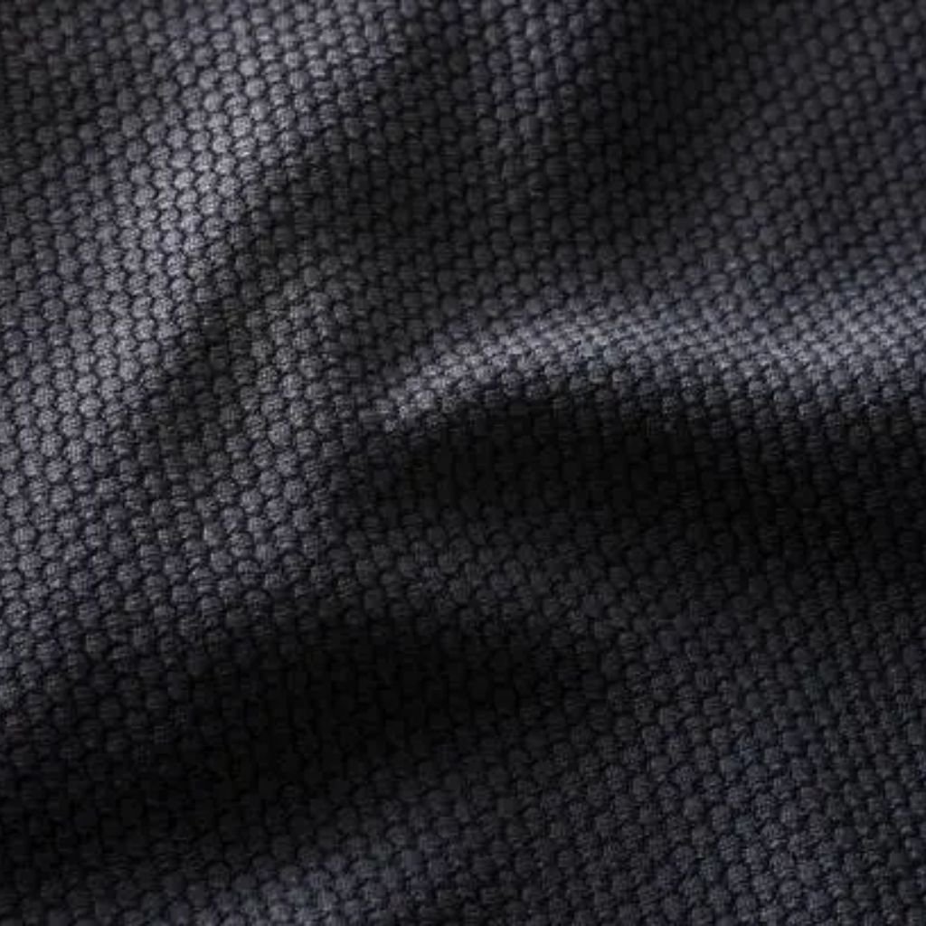 Infinity Dry Performance Fabric: Sweat-Wicking Comfort Gear 8 Close-up of dark textured fabric with a small, tightly woven honeycomb-like pattern and gentle folds.Infinity Dry Performance Fabric: