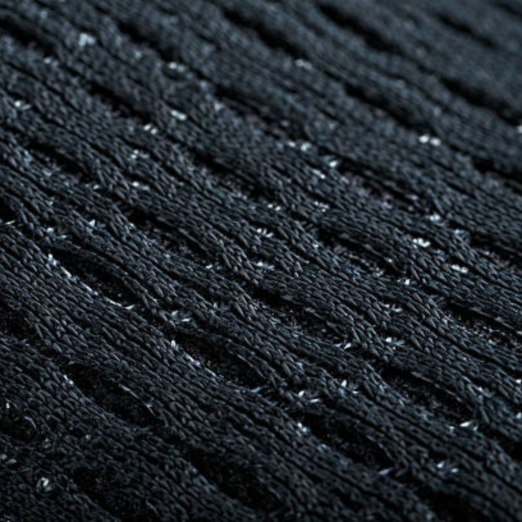 Frost Air Performance Knit: Cool Comfort Fabric for Athletes 8 Close-up of dark military-grade knit fabric with rhythmic rows, micro-perforations for breathability, and subtle frost-like specks.
Frost Air Performance Knit: