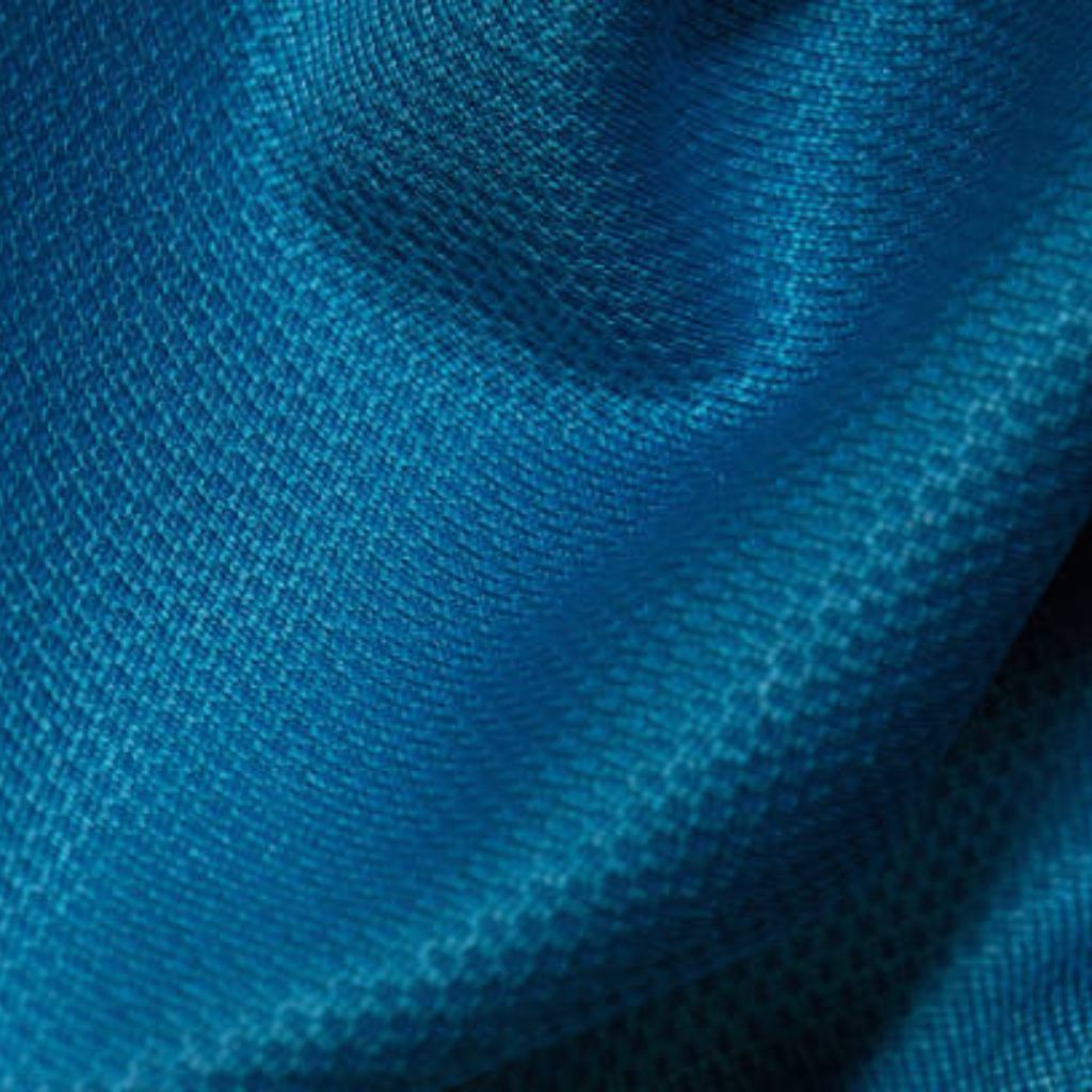 Close-up of navy-blue wool-acrylic blend fabric with herringbone weave: interlocking V-shaped motifs, subtle sheen, and fine tonal variation across raised ridges.
Aqua Wick Performance Textile:

