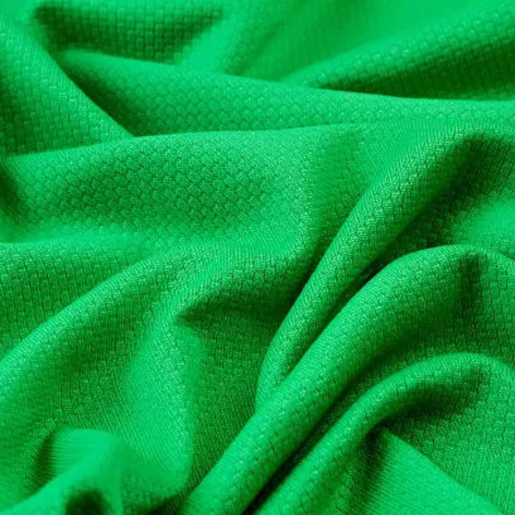 Green Flex Athletic Knit: Future of Eco-Friendly Activewear 7 "Close-up of rugged olive-green fabric with visible twill weave texture and deep folds, used in military-inspired winter jackets"
Green Flex Athletic Knit: