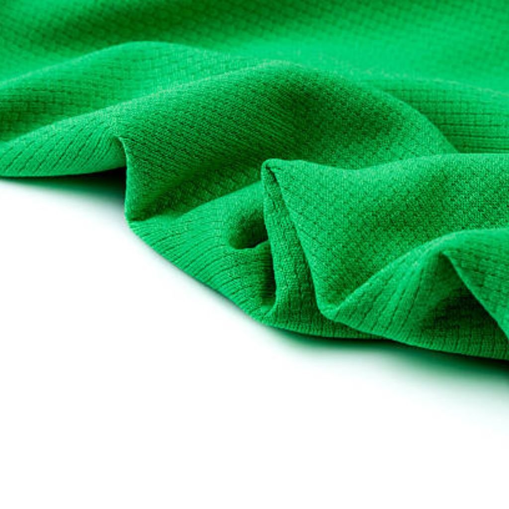 Green Flex Athletic Knit: Future of Eco-Friendly Activewear 10 "Close-up of rugged olive-green fabric with visible twill weave texture and deep folds, used in military-inspired winter jackets"
Green Flex Athletic Knit: