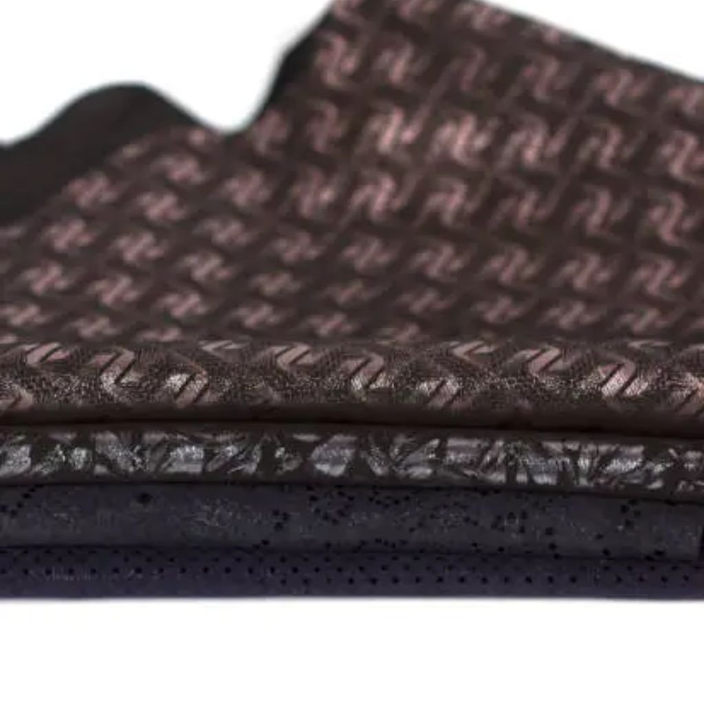 Neo Dry Tech Fabric: Ultimate Moisture Control for Athletes 10 Three stacked fabric swatches: dark brown angular-patterned textile, light brown textured/floral weave, and dark blue perforated material — all on white.
Neo Dry Tech Fabric: