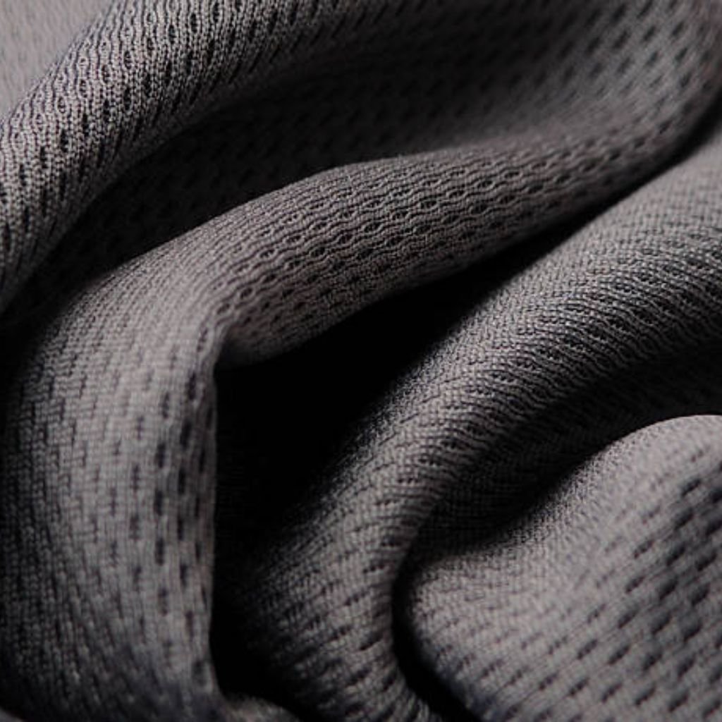 Rapid Dry Sports Knit: Train Hard, Stay Dry, Perform Better 11 Grey athletic mesh fabric close-up: visible diamond-weave structure, uniform micro-perforations, and dimensional folds for breathability and stretch.
Rapid Dry Sports Knit: