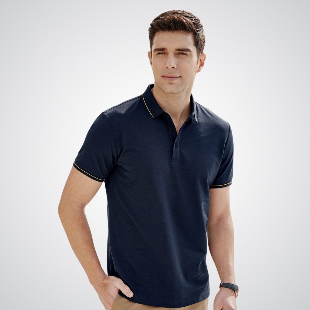 Modern-style man wearing a navy polo shirt with a clean, trendy design against a plain studio background.

