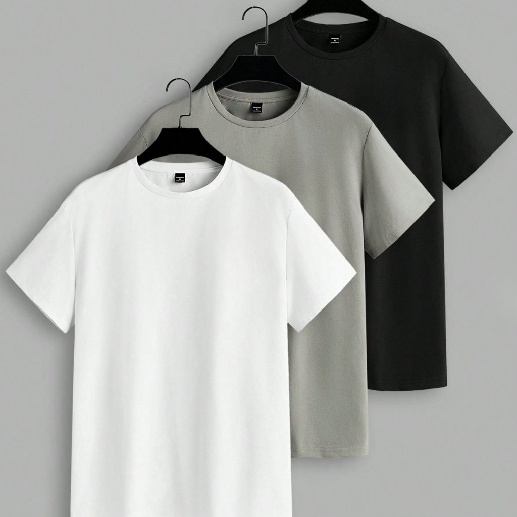 Set of modern short-sleeve t-shirts in black, gray, and white hanging on hangers against a plain background.

