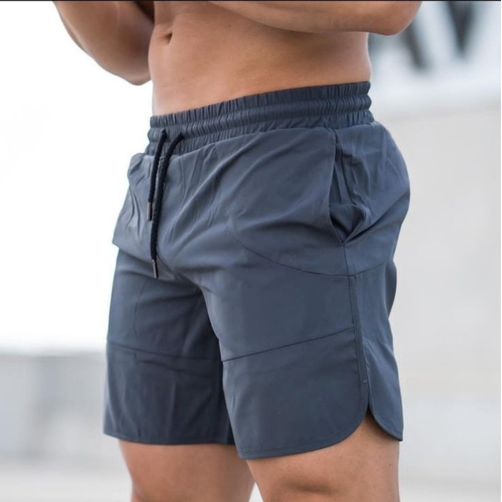Casual Beachwear Essentials: Stylish Swim Shorts 10 A model wearing dark navy drawstring swim shorts with an elastic waistband.