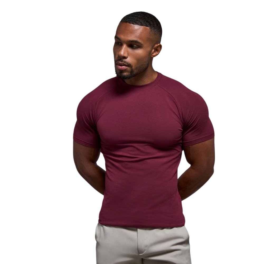 Muscle Fit T-Shirts That Define Your Body Shape 6 Man wearing a style Muscle-Fit T-Shirts in a deep maroon color with a fitted silhouette on a clean studio background