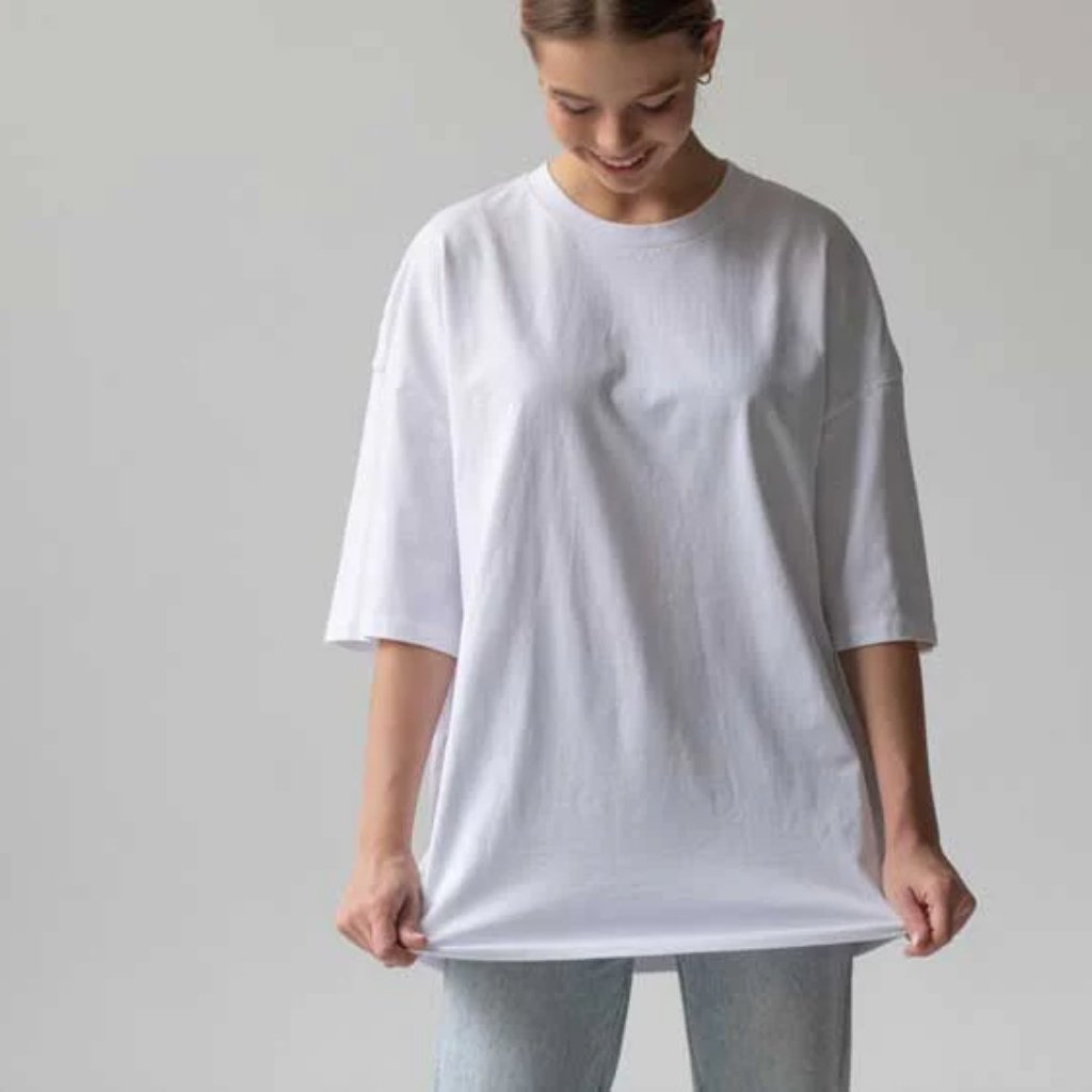 Oversized T-Shirts for Men: Streetwear Style, Relaxed Fit 5 Woman wearing an oversized white T-shirt with a relaxed fit.