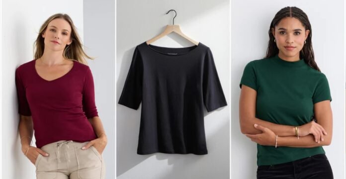 Three women wearing women’s t-shirts in burgundy, black, and green, shown from waist-up, with a black t-shirt displayed on a hanger in the center.