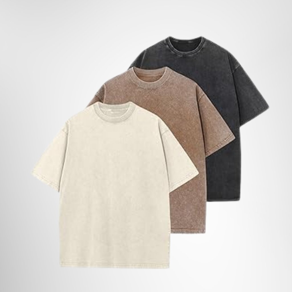 Set of three soft cotton T-shirts in white, beige-brown, and black, neatly folded and stacked.

