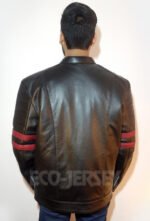 Back view of a black leather jacket with red stripes, worn by a young man.