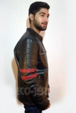 Young man in a black leather jacket with red stripes, seen from the side.