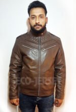 Man wearing a black leather motorbike jacket with quilted shoulders, standing at a front-side angle showing the fit and zipper details.