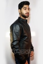 A side profile of a young man wearing a black leather jacket, emphasizing the jacket’s stylish cut against a white background.