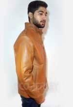 Side view of a young man in a brown leather jacket featuring a high collar and quilted shoulder design.