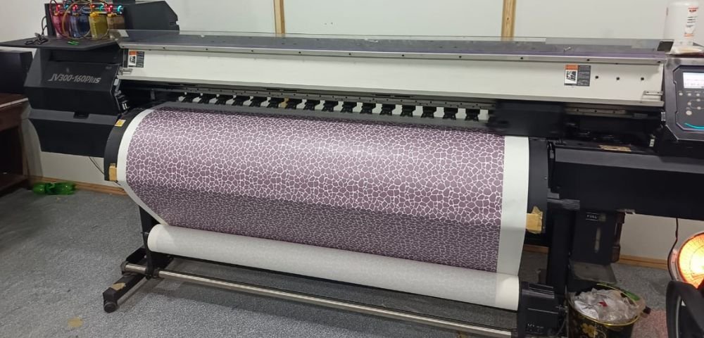 Sublimation machine, printing design on sublimation paper to transfer it on specific sportswear garment.