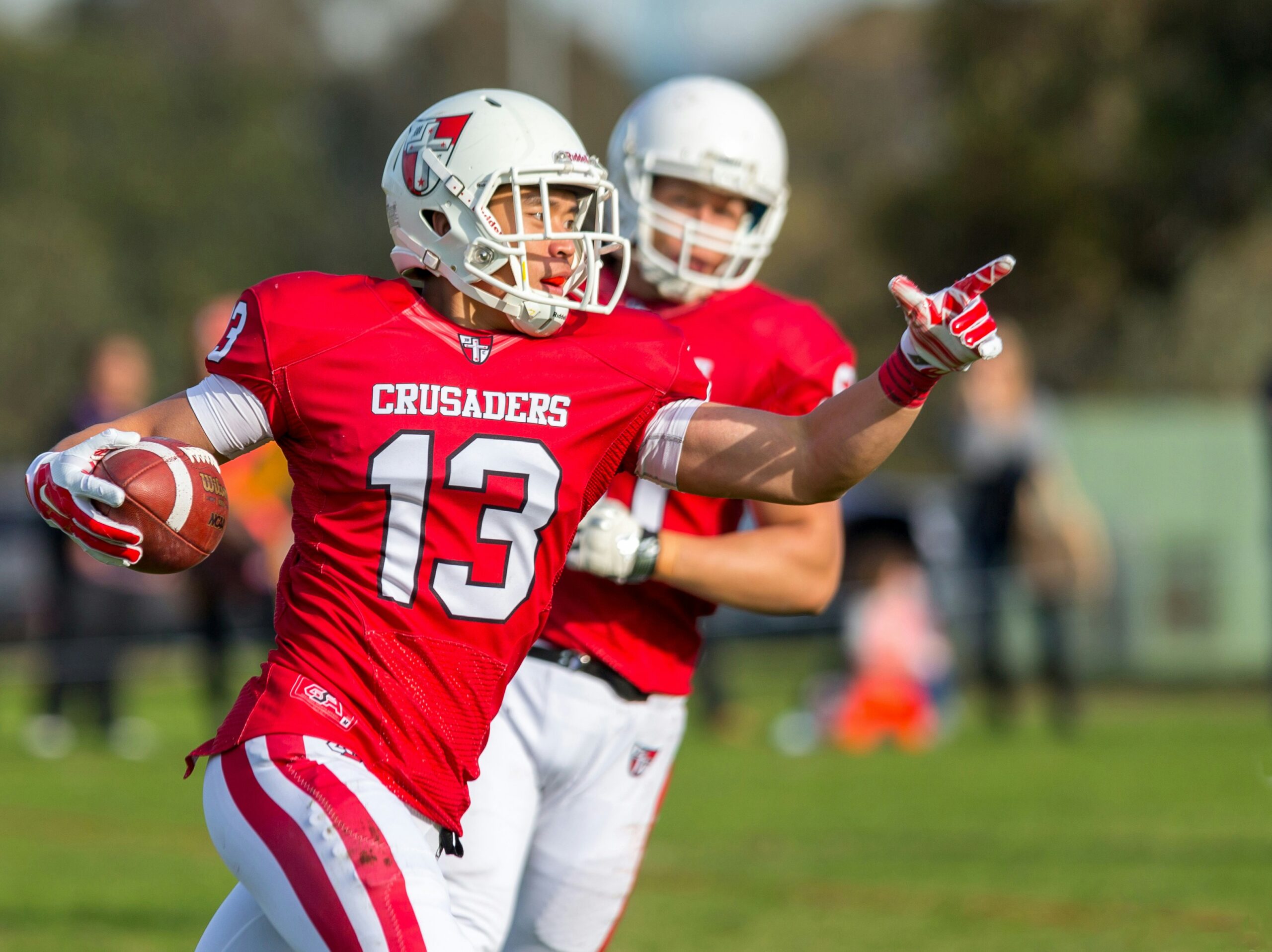 Two players of American Football trying to reach their goal.