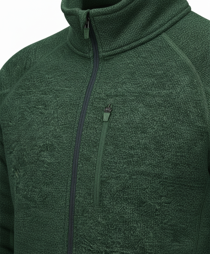 Close-up of a dark green textured fleece jacket with a front zipper and a vertical chest pocket.
