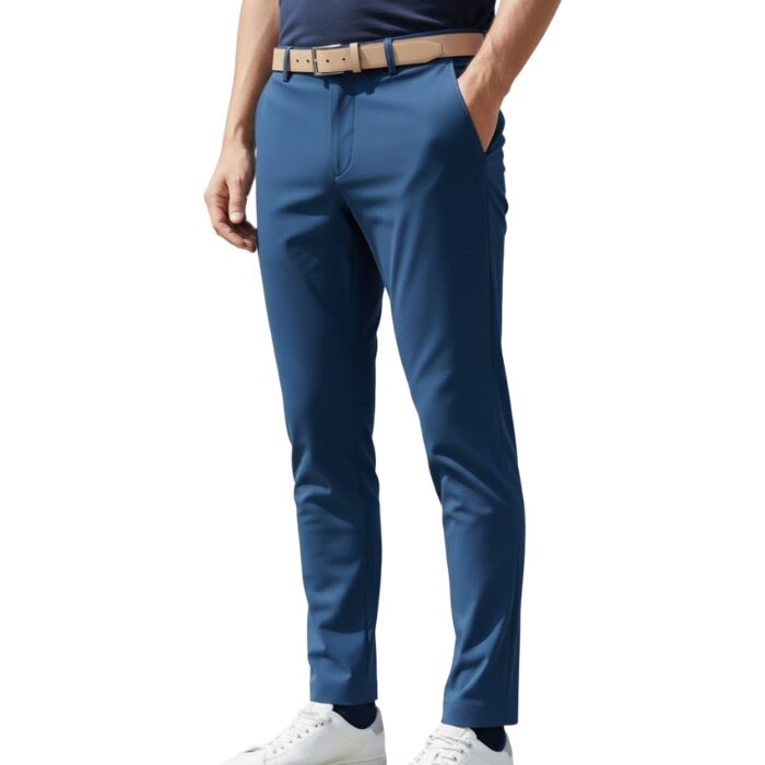 Man wearing blue slim-fit stretch golf pant with tan belt and white sneakers, posing with one hand in pocket against a white background
