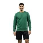 Man wearing a green long-sleeve badminton sweatshirt and black athletic shorts on a white background.