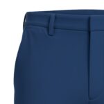 Front close-up of dark blue men’s slim-fit stretch golf pant showing waistband, belt loops, and front pocket area