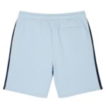 Light blue tennis shorts shown from the back with a dark blue stripe down each side, an elastic waistband, and a small back pocket on the right. The fabric looks smooth and athletic