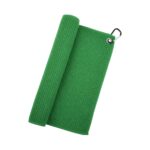 A bright green waffle-textured golf towel partially rolled on the left with a silver grommet and black carabiner on the top-right corner.