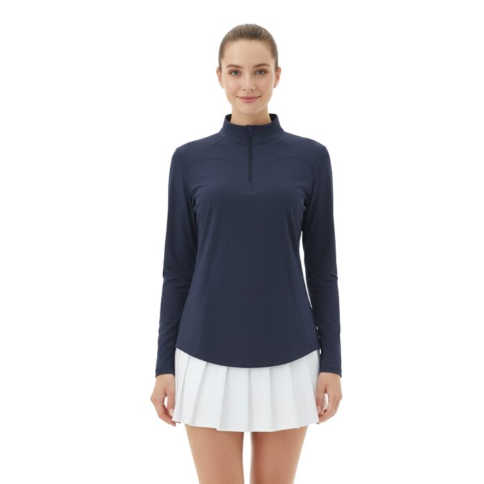 Front view of a woman wearing a navy long-sleeve golf top with a white pleated skirt.
