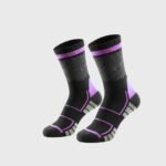 A studio shot of a pair of crew-length socks with a black base, purple and gray accents, featuring a geometric pattern near the top and horizontal stripes with angled segments on the lower portion, shown on a plain white background.