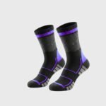 A pair of black performance court socks with gray textured panels, blue accent bands at the cuff, ankle, and midfoot, and white detailing at the heel and toe, displayed on a light gray background.