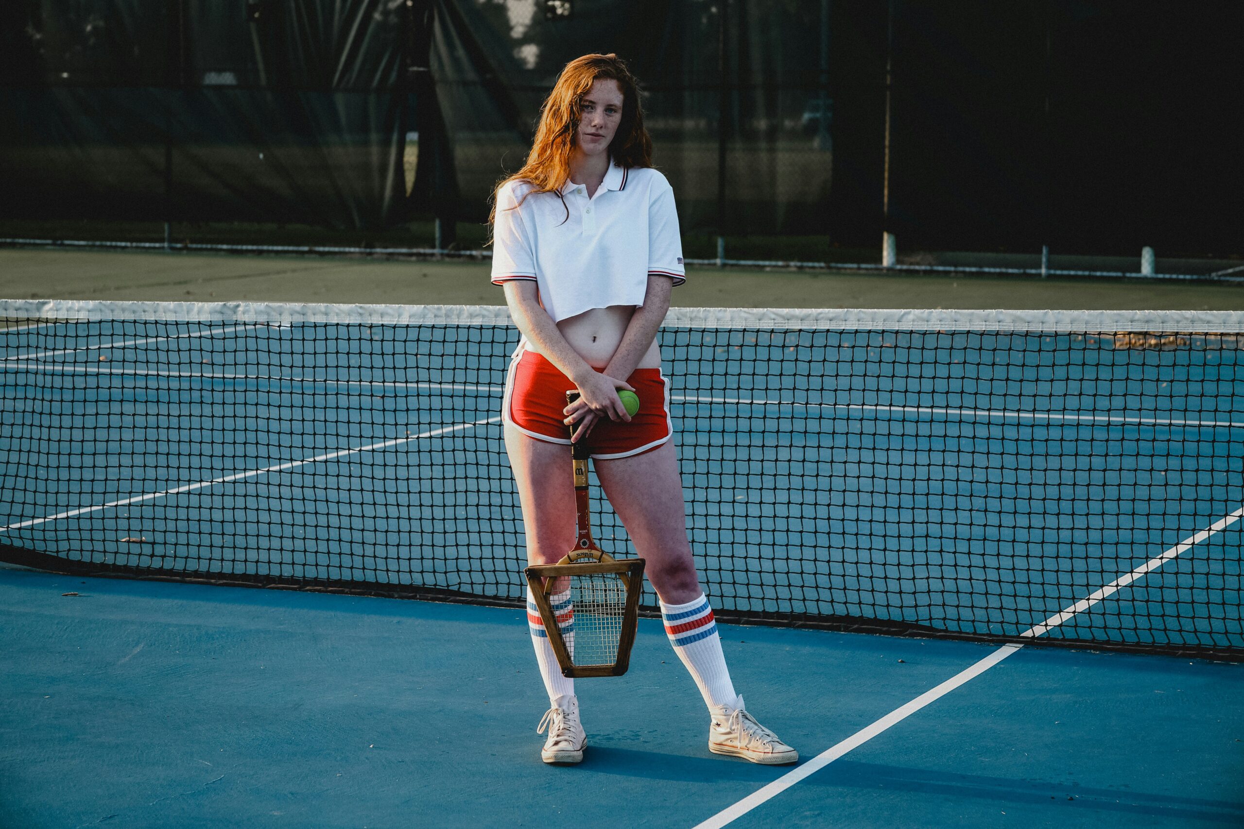 A women standing by wearing Tennis Apparel.