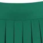 Close-up of a bright green pleated golf skort waistband and sharp pleats.