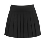Front view of a black pleated golf skort with a wide waistband.