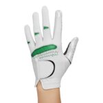 A white women's golf glove with green accents on the back of the hand, shown on a right hand against a white background.